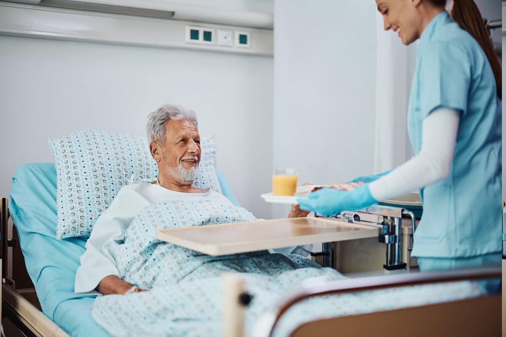 Persona mayor comiendo en hospital