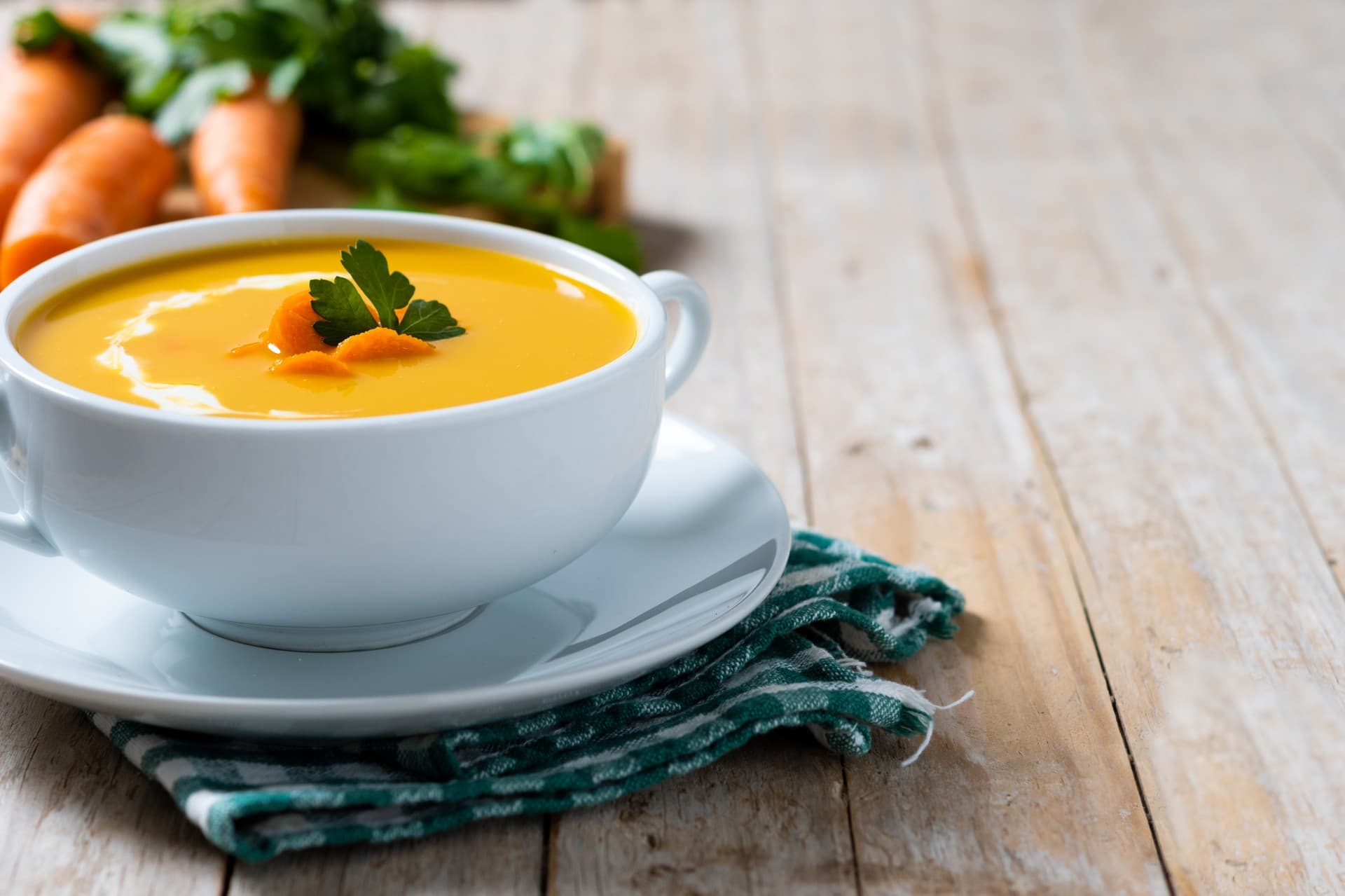 carrot soup with cream parsley wooden table
